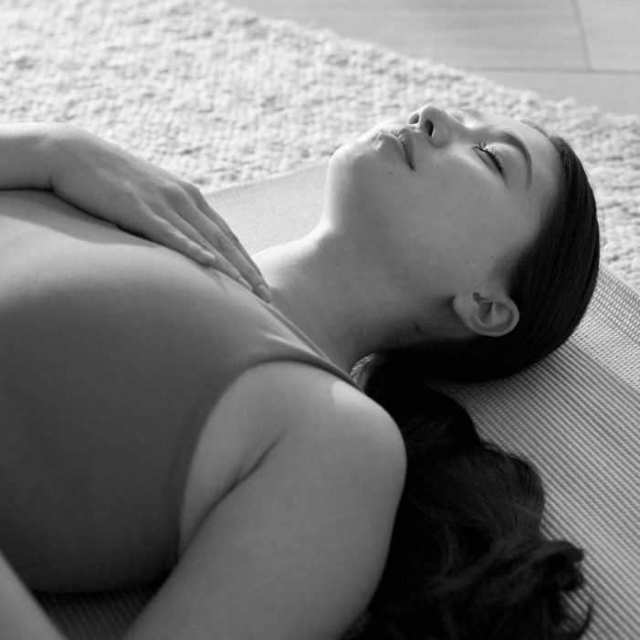 Breathe, meditation and Asian woman in home on floor for mindfulness, wellness and inner peace. Morning, apartment and person on mat for breathing exercise, spiritual awareness and reflection